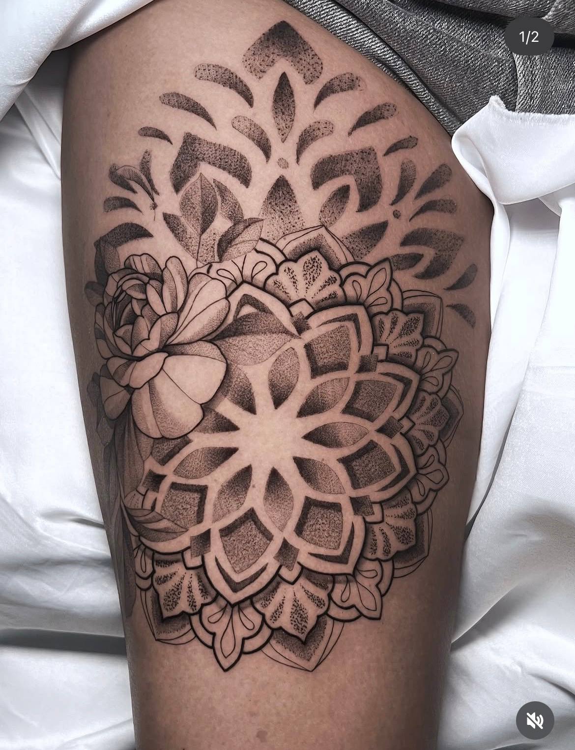 Floral dotwork mandala tattoo on the thigh using stippling