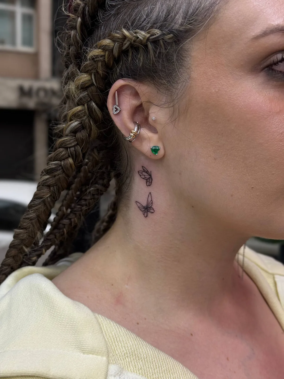 Boyun kelebek dövmesi ve helix, tragus, daith kulak piercing kombinasyonu